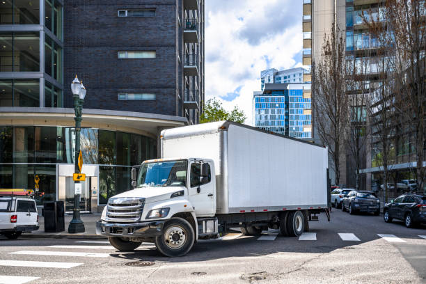 "2009 Chevrolet C6500 Box Truck 13'6" parked on a worksite."