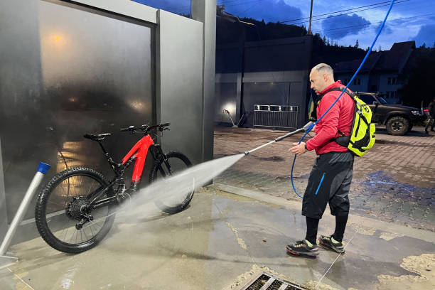 “Evotia power washer cleaning a driveway”