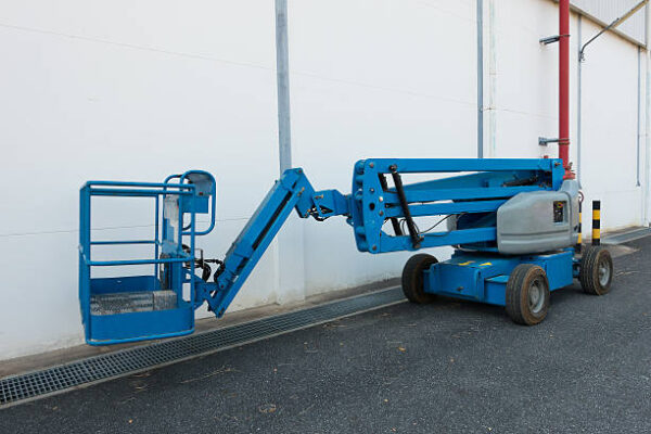 A telescopic handler forklift 1957 lifting construction materials at a job site.