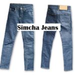 A pair of stylish blue simcha jeans displayed with casual outfit styling.