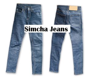 A pair of stylish blue simcha jeans displayed with casual outfit styling.